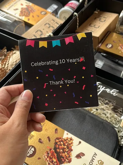 A close-up of the custom "Celebrating 10 Years" thank you card included in the Bloomberg anniversary hampers, adding a personal and celebratory touch.