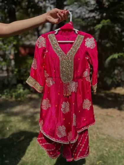 The fuchsia Gota Patti sharara set. The color is vibrant, and the gold work is exquisite.
