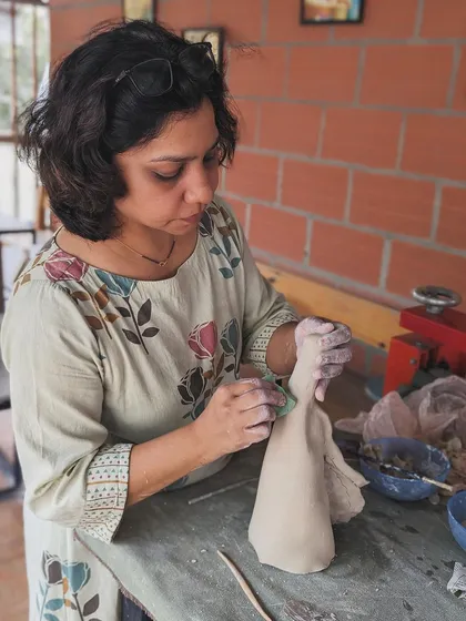 A student fully absorbed in creating a delicate sculpture. Hand-building is a very mindful and peaceful activity.