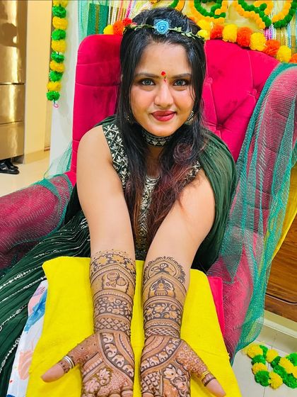 A beautiful bride ready for her mehndi ceremony, showcasing her intricate design.