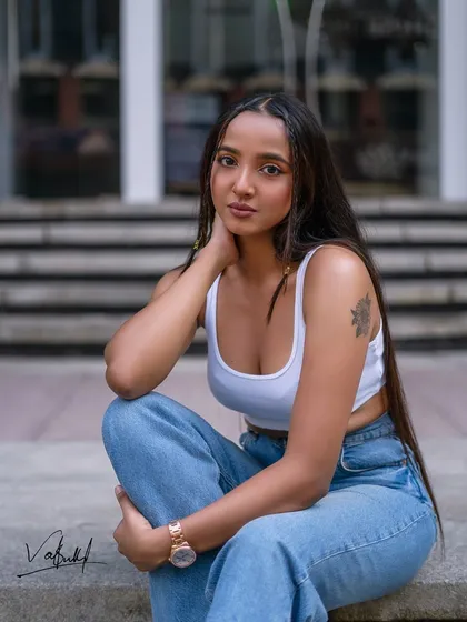 A seated portrait from our urban fashion shoot. This pose feels relaxed and contemplative, offering a different mood while still maintaining a cool, street-style aesthetic.