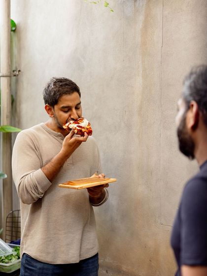 One of our founders enjoying a slice of the new Pizza Romana.