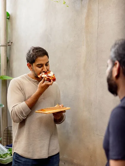 One of our founders enjoying a slice of the new Pizza Romana.