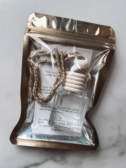 My hanging car air freshener comes in a sleek, convenient pouch with instructions. It's an easy and effective way to enjoy premium fragrance on the go, and is available for bulk orders.