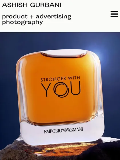 An Emporio Armani fragrance bottle acting as a paperweight. This was a simple idea that came to me in the studio, using a strong backlight to make the bottle glow against a piece of rock.