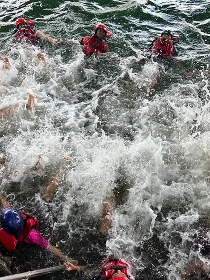 A splashy, fun-filled moment as a group of campers enjoys a swim break in the river at Dandeli.