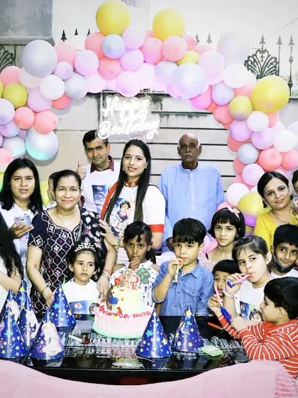 A happy group photo from a family birthday celebration. The pastel balloon arch provided a lovely backdrop for their memories.