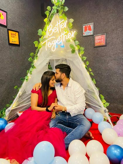 A cozy and romantic birthday celebration. This client looks beautiful in a wine-colored gown, enjoying an intimate moment.