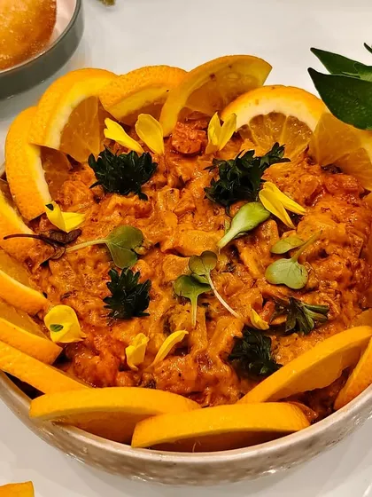When food meets art. A burst of flavors, colors, and freshness all in one bowl, beautifully garnished with orange slices and edible flowers.