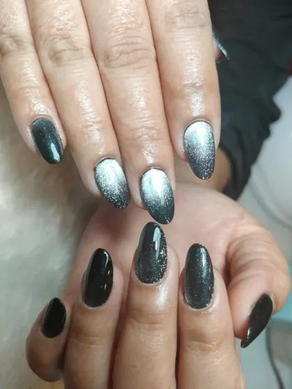 A striking black and silver cat-eye ombre, creating a beautiful gradient effect with a magnetic shimmer.