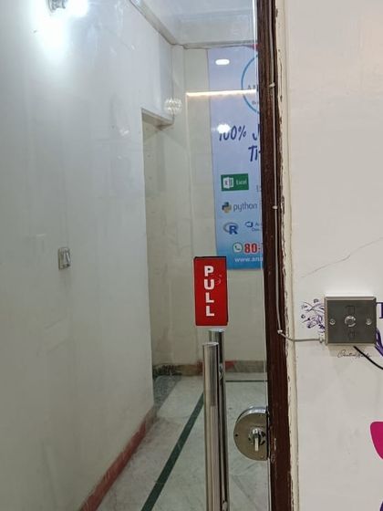 Here you can see the full entrance setup at the institute, with the biometric reader controlling access through the glass door. The 'PULL' handle and lock mechanism work together with the electronic system.