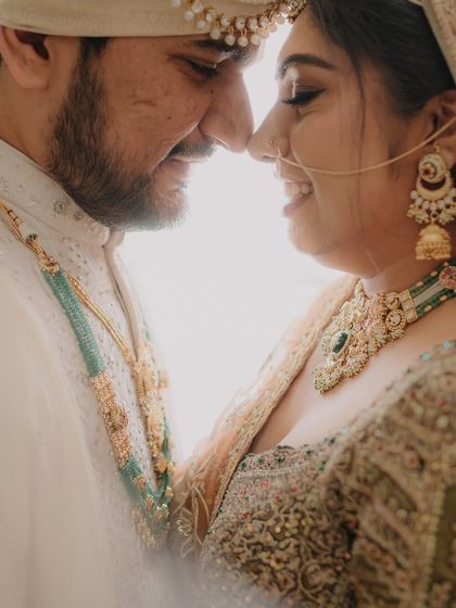 An intimate and romantic close-up, capturing the couple just a moment before a kiss. The bright backlighting creates a dreamy, ethereal feel.