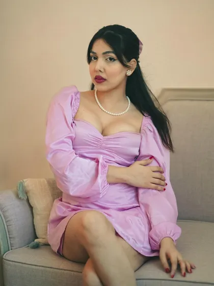 A classic portrait with a vintage feel. The pearl necklace, the dress style, and the soft lighting all come together to create a timeless, elegant look.