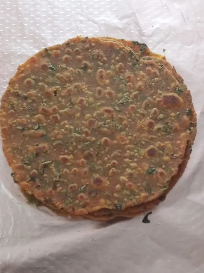 A simple stack of our soft, homemade methi theplas. We make these traditional Gujarati flatbreads with fresh fenugreek leaves and whole wheat flour, perfect for a quick snack or as part of a larger meal.