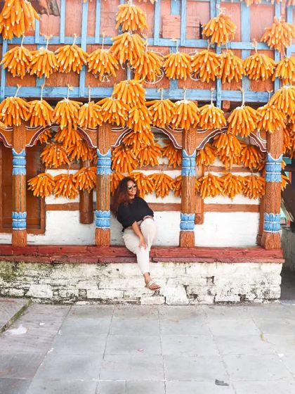 Taking a moment to relax at the corn village. My simple Zara top and track pants were the perfect comfortable travel wear for a day of exploring.