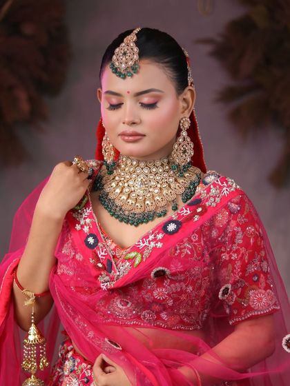 From learners to artists. Our students master the art of bridal makeup, creating breathtaking looks like this one with a vibrant pink lehenga and heavy kundan jewelry.