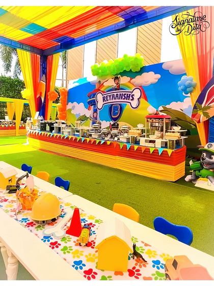 The main buffet and dining area for the Paw Patrol party. The backdrop, table runner, and even the kids' hard hats are all themed, creating a cohesive and exciting environment.