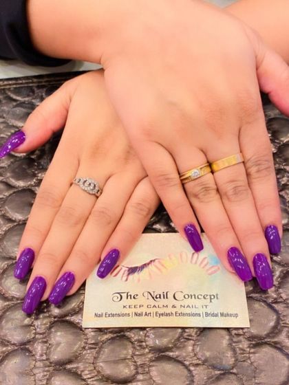 A bold and beautiful set of long, square nails in a solid, glossy deep purple. This rich color is perfect for a dramatic and stylish look.