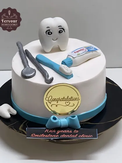A cake to celebrate the 10-year anniversary of a dental clinic. This chocolate mousse cake is decorated with a cute fondant tooth, toothbrush, and dental tools.