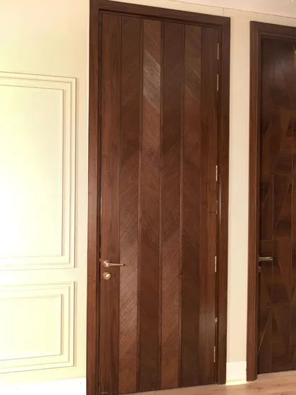 To create a sense of height and drama, I designed this door with an American walnut veneer in a chevron-style ripped flute pattern. It's a powerful design that draws the eye upward.