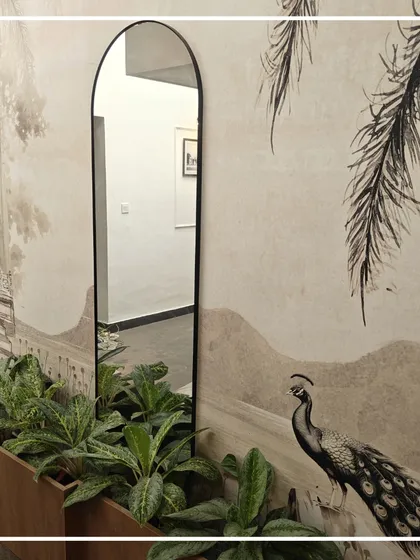 This transition space at the Bangalore Club features a custom heritage-inspired wallpaper, an elegant arched mirror, and integrated planters. It demonstrates our approach to making every part of a building, including hallways, a thoughtful and beautiful experience.
