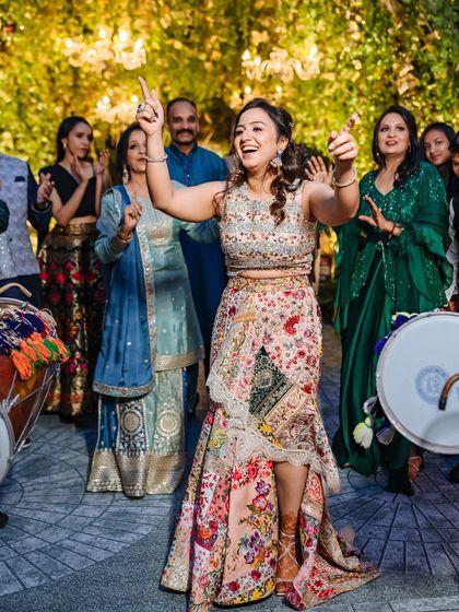 A bride dances with pure abandon to the beat of the dhol, her energy lighting up the Mehendi celebration in Chandigarh.