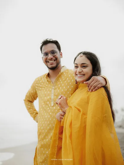 A joyful portrait of the couple on the beach, their bright smiles reflecting the happiness of their pre-wedding celebration.