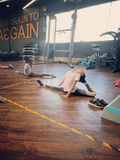 Flexibility training is a key part of our curriculum. Here, a student works on her middle split and back flexibility, essential skills for any serious jazz dancer.