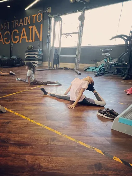 Flexibility training is a key part of our curriculum. Here, a student works on her middle split and back flexibility, essential skills for any serious jazz dancer.