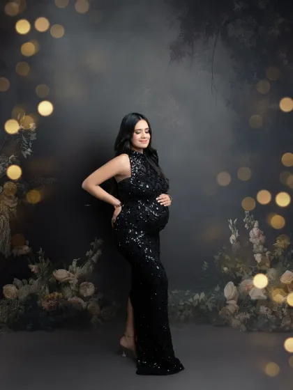 A glamorous couple's portrait with a touch of magic. The bokeh lights and floral arrangements create a dreamy backdrop for the elegantly dressed pair.
