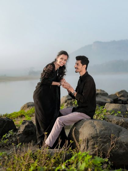 A playful interaction on the rocks by the lake. Even in quiet settings, we can capture moments of fun and laughter.