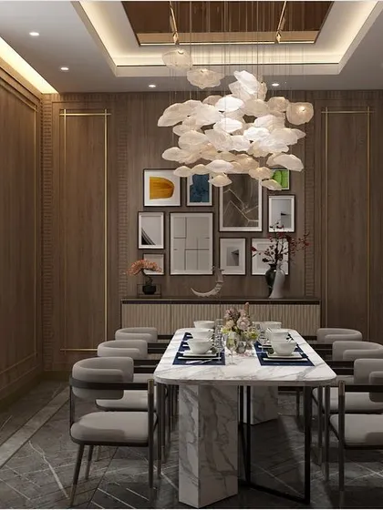 This dining area is infused with an understated yet modern spirit. I used wood-paneled walls, a gallery wall of art, and a cloud-like chandelier to create a space that feels both timeless and contemporary.