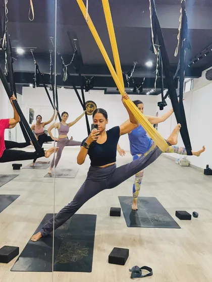 A mirror selfie capturing the energy of a full class. Our instructor leads a group of students through a synchronized stretching sequence.