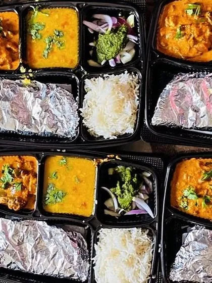 A set of thalis with Kadai Paneer and Dal Tadka, prepared for a group lunch. The green chutney and salad are always freshly made.