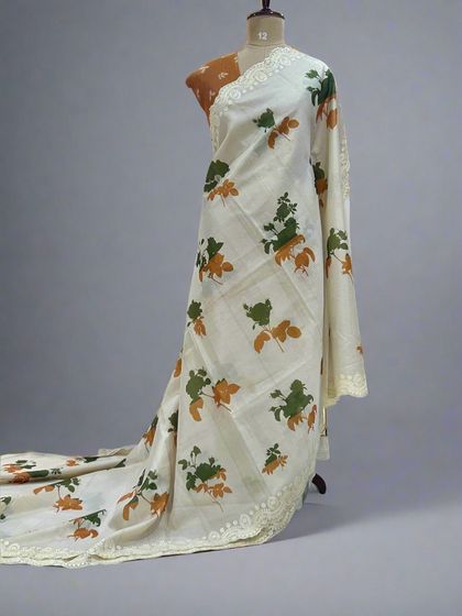 A full-length view of the Kota checks saree with green and orange prints, showing its light and airy drape.