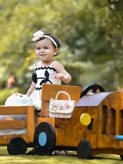 All aboard the teddy bear express for a first birthday adventure. I love taking shoots outdoors to use beautiful natural light. This custom-built train prop is just one of the many ways I bring big, imaginative ideas to life for your child's milestone celebration.