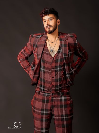 A relaxed and confident full-body shot. The styling and pose work together to create a modern and fashionable look.