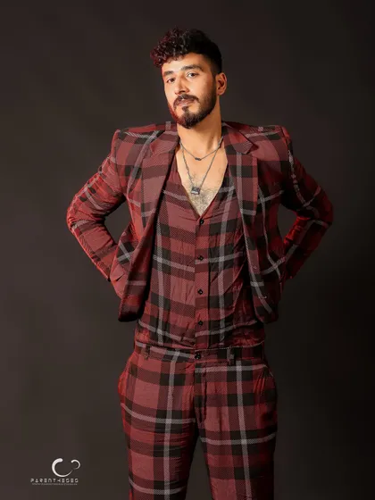 A relaxed and confident full-body shot. The styling and pose work together to create a modern and fashionable look.
