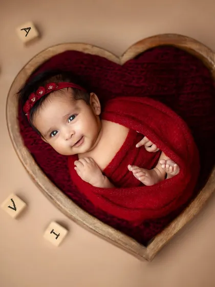 A classic and timeless portrait. I use soft wraps and beautiful props like this heart-shaped wooden bowl to create artistic, peaceful images of your newborn.