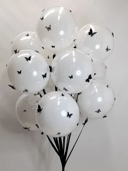 A simple but beautiful bunch of giant white balloons decorated with black butterfly decals. This is a chic and modern take on a classic balloon bouquet.