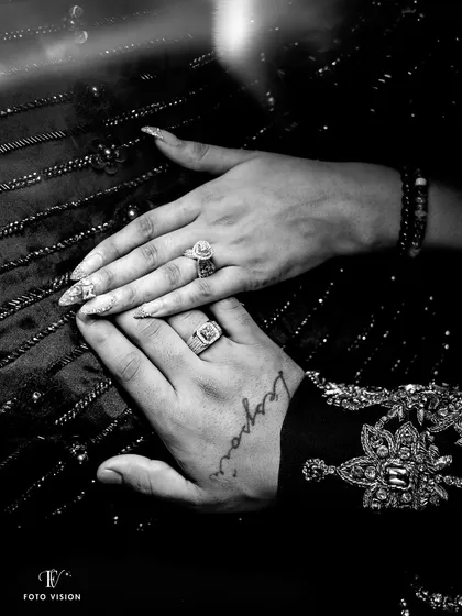 A detail shot of the couple's hands, showing their rings and the groom's tattoo. We believe in capturing the small details that tell a bigger story about the couple.