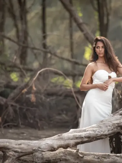A powerful and dramatic pose from an editorial bridal shoot. The lighting and the wild, natural location create a stunning and unconventional portrait.
