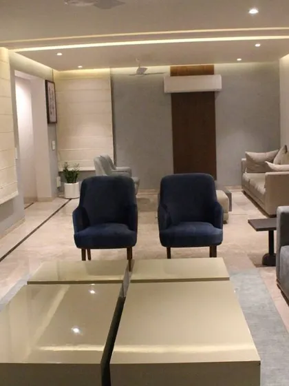 A wider view of the Hyderabad living area, showing how the different furniture pieces create a cohesive and spacious seating arrangement. The neutral color palette is accented with touches of blue and wood.