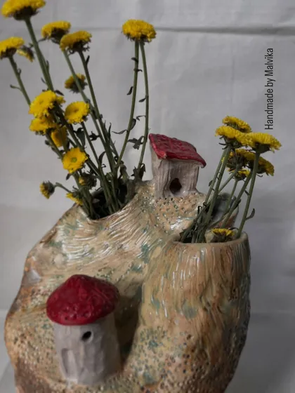 This is a piece from my 'Houses on Cliff' series, a collection that is very close to my heart. It’s inspired by my travels to the *pahad* (mountains), trying to capture the feeling of a quiet home nestled in nature. This ceramic art piece functions as a unique vase, perfect for holding wildflowers and memories.