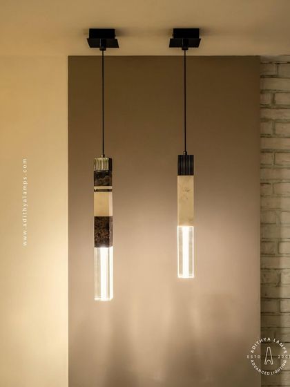 A collection of our pillar pendants, which combine sections of solid marble, fluted metal, and clear crystal. These substantial, high-quality fixtures can be hung individually or in clusters to create a dramatic effect in stairwells or entryways.