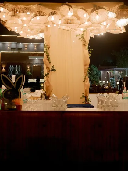 The rustic basket chandelier lighting up the bar area at night, creating a cozy and stylish atmosphere.