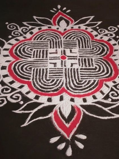 A stunning Kolam design, a geometric line drawing composed of curved loops, drawn around a grid pattern of dots.