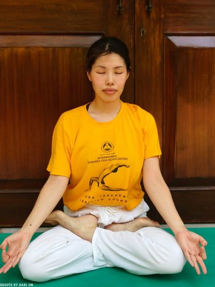 A student in a meditative pose, representing the calm and positive attitude we cultivate in our workshops. These sessions provide yogic techniques to manage emotions like fear and anxiety.