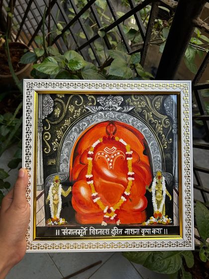 The finished 1x1 ft painting of Shri Mayureshwar Ganpati, one of the Ashtavinayak temples. The piece is framed and ready to be placed in a home, with the mantra 'Sankatamurti Vidnahara Durit Nashana Kripa Kara' written below.