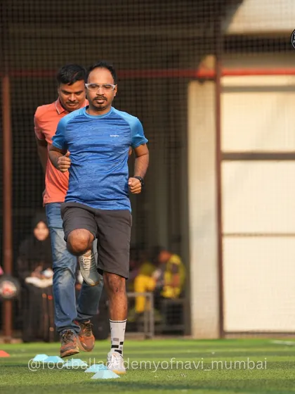 A father focuses on a running drill during a training session for parents. We provide a structured yet relaxed environment for adults to improve their fitness and football skills.